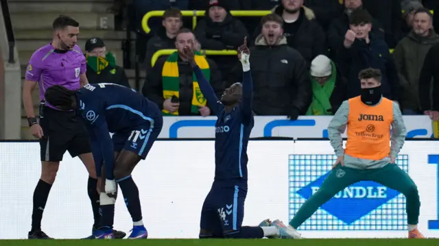 Romain Esse raises both arms to the sky in celebration