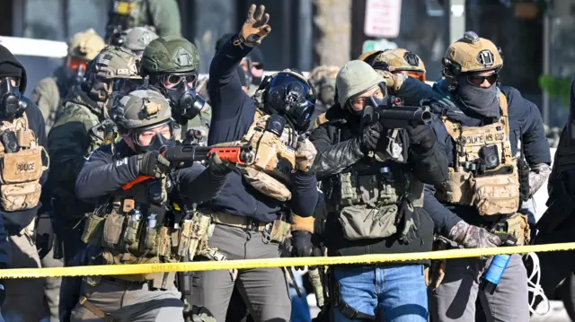 Federal officers throw teagas canister and fire less-lethal rounds as they confront protesters after ICE fatally shot a man several times while they were trying to detain him in Minneapolis, Minnesota, USA, 24 January