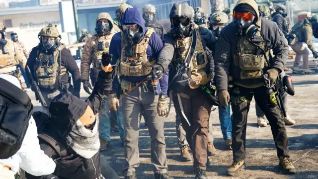 Federal officers confronting a protester following the fatal shooting of a man in the city on Saturday 24 January