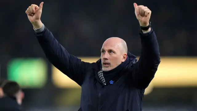 Norwich boss Philippe Clement raises both arms in celebration