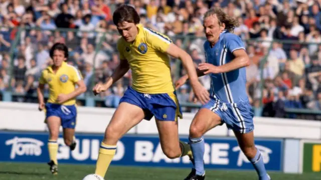 Terry Yorath in the light blue shirt of Coventry, tackling a player in a yellow shirt