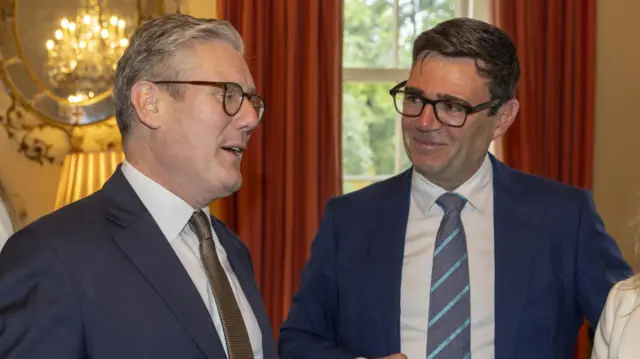 File photo of Starmer speaking with Burnham smiling and looking on