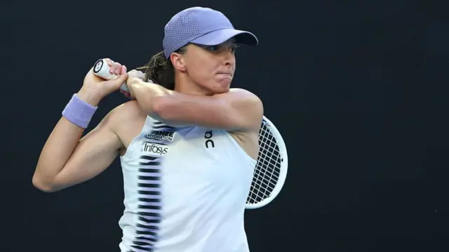 Iga Swiatek hits a backhand