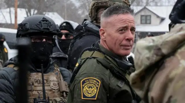 Border Patrol commander Greg Bovino with several masked agents