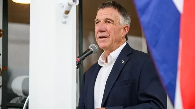 Govenor Phill Scott speaking into a microphone