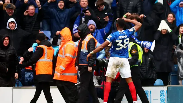 Ebou Adams salutes the home fans at Fratton Park after scoring against Southampton