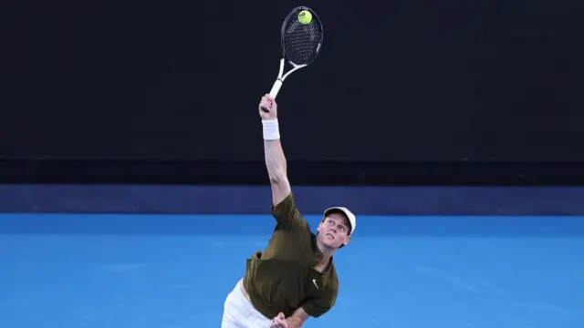 Jannik Sinner serves
