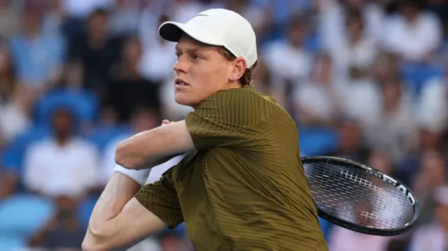 Jannik Sinner after hitting a backhand