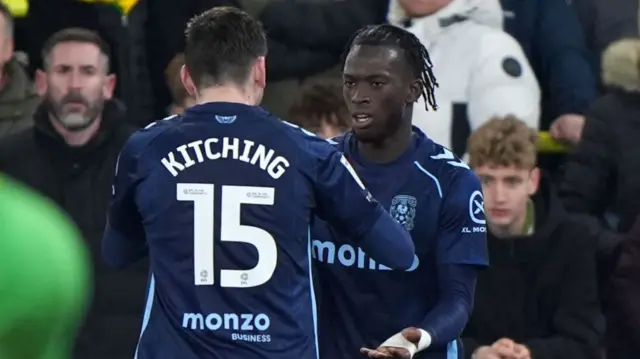 Romain Esse celebrates his goal with Liam Kitching