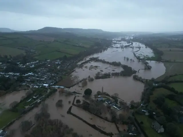 A large field that appears to be flooded. The sky is grey and cloudy.