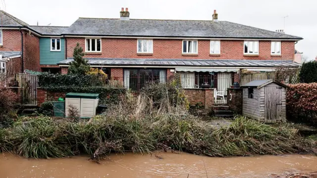 House with floodwater directly in front of it