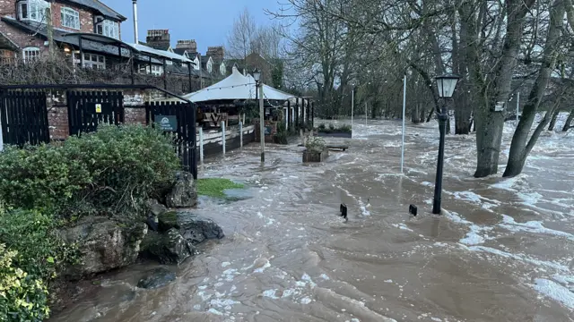 Outside of the Mill on the Exe pub. There is flood water surrounding the premisis.