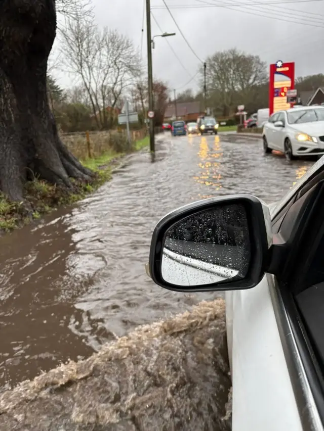 Cars struggling through water-logged streets in Romsey.
