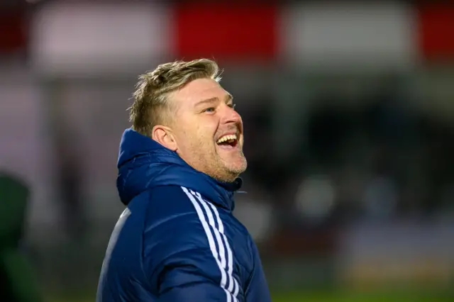 Karl Robinson smiles on the touchline during Salford's 3-2 win over Swindon in the FA Cup third round