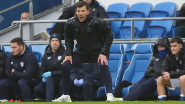 Brian Barry-Murphy with hands on knees in the Cardiff dugout