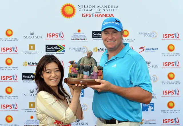 Dawie Van Der Walt of South Africa is presented with the trophy by Midori Miyazaki, ISPS international executive director ,after the Nelson Mandela Championship
