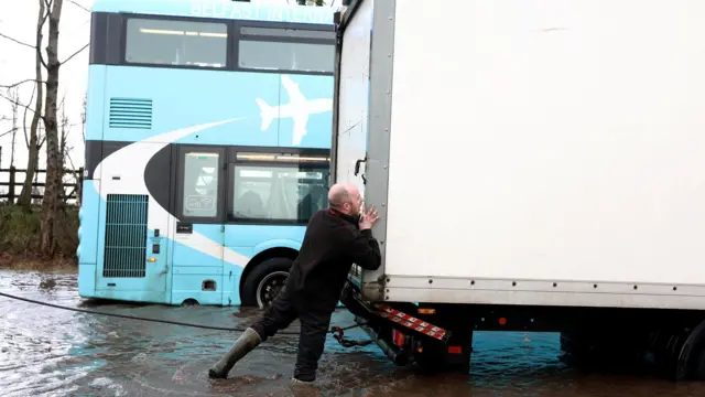 A man pushes a lorry in Antrim Northern Ireland