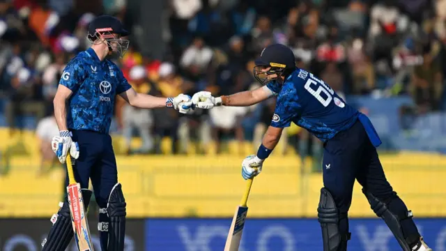 Joe Root and captain Harry Brook bump fists