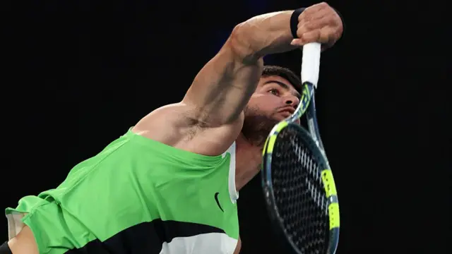 Carlos Alcaraz serves