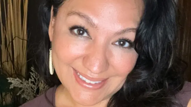 close-up of smiling woman with dark hair
