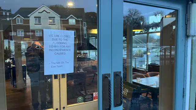 A sign on the door of the pub. I