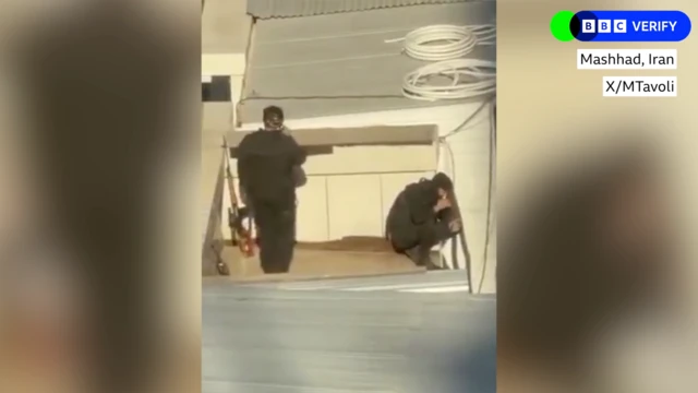 Two men with a sniper rifle on a roof