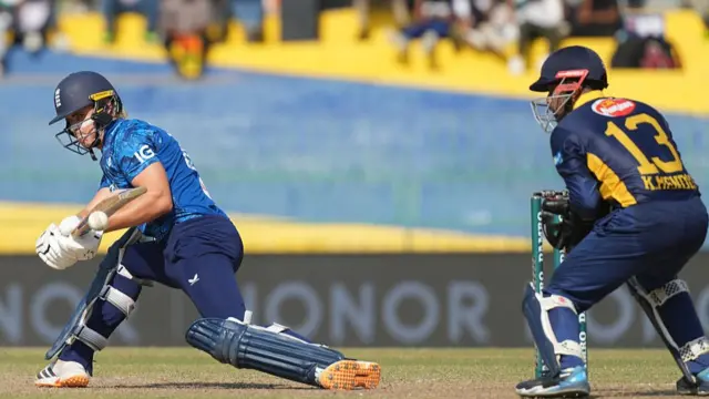 Jacob Bethell of England playing a shot