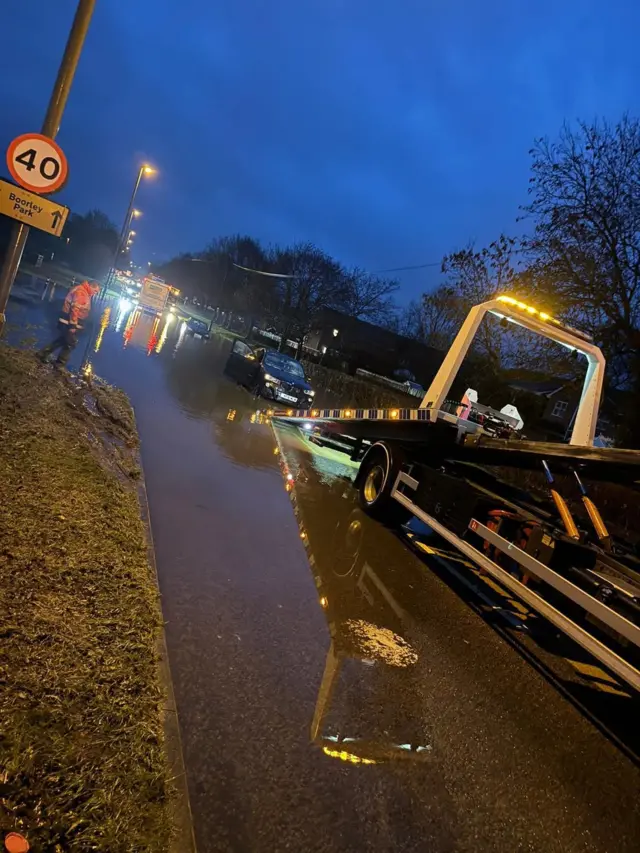 Vehicles being recovered at Toll Bar Road in Hedge End in the early morning. The road is flooded.