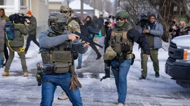 ICE and other federal officers stand at a Minneapolis intersection where protesters had gathered after the death of Renee Good.
