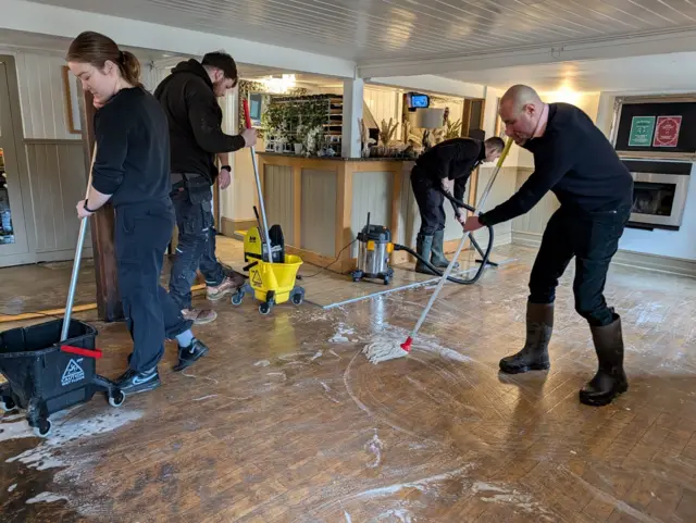 The Royal Oak staff using mops on the floor