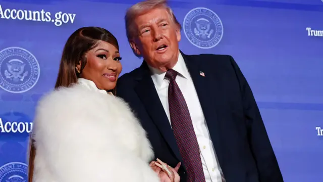 U.S. President Donald Trump and musician Nicki Minaj hold hands onstage at the U.S. Treasury Department's Trump Accounts Summit, in Washington, D.C., U.S. January 28, 2026.