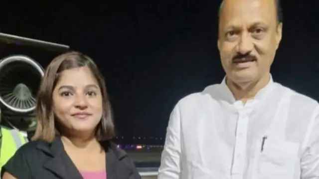 Pinky Mali in a black shirt and pink top seen with Ajit Pawar who is wearing white kurta