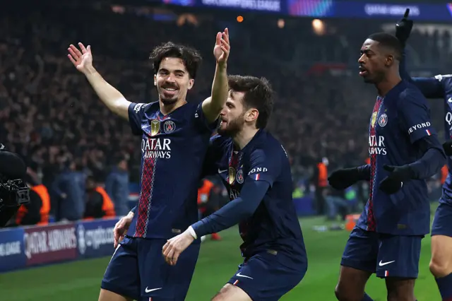 Paris Saint-Germain's Portuguese midfielder #17 Vitinha (L) celebrates