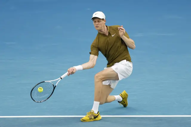 Jannik Sinner hits a forehand