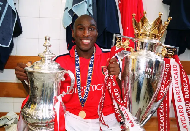 Sol Campbell with FA Cup and Premier League trophies