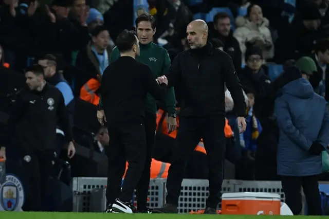 Head Coach of Galatasaray Okan Buruk and Head coach of Manchester City Pep Guardiola are seen after