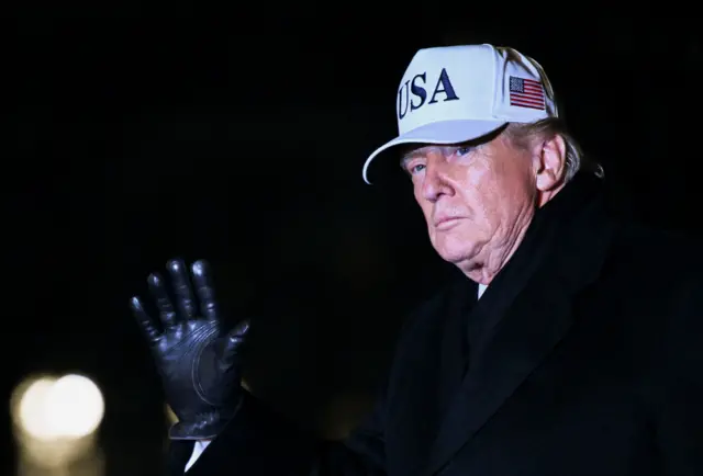 U.S. President Donald Trump waves as he walks upon arrival on the South Lawn of the White House