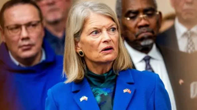 Republican Senator for Alaska Lisa Murkowski wearing a bright blue jacket with US, Danish and Greenlandic lapel pins