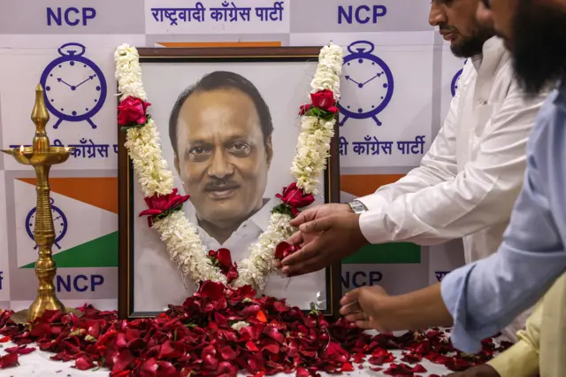 Indian supporters of Maharashtra Deputy Chief Minister Ajit Pawar pay homage near his photograph at the party head office in Mumbai, India, 28 January 2026, after he was killed in a plane crash
