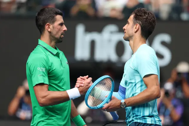 Novak Djokovic shakes hands with Lorenzo Musetti