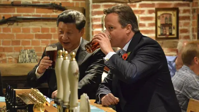 Chinese President Xi Jinping and then-Prime Minister David Cameron drinking in The Plough at Cadsden pub, near the PM's residence at Chequers, in 2015 - a period of warmer UK-China relations