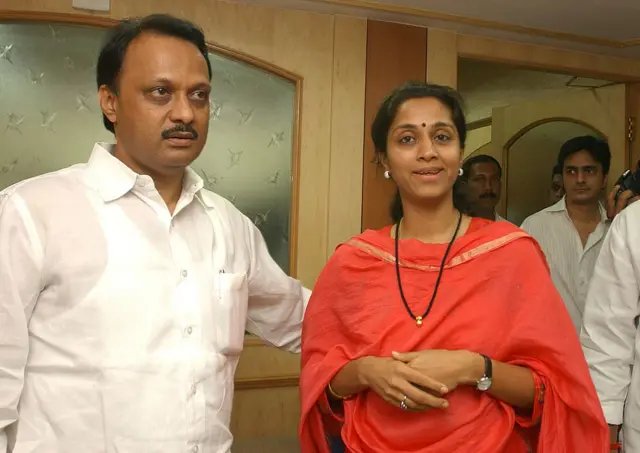 Ajit Pawar (left) in white shirt with Supriya Sule (right) in a deep orange kurta and dupatta