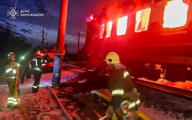Ukrainian rescuers working at the site of a Russian drone hit on the passenger train near the city of Izyum in Kharkiv's area, Ukraine