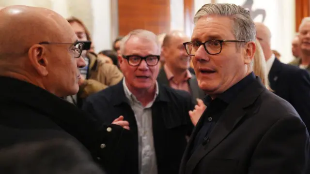 Keir starmer speaks in the lobby of a beijing hotel.