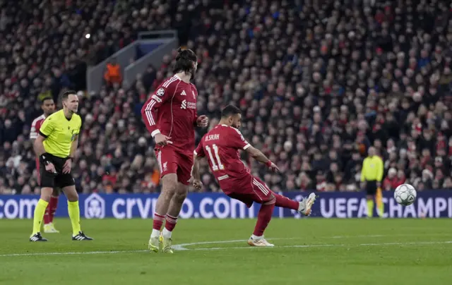 Liverpool's Mohamed Salah scores their side's third goal