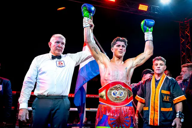 Gradus Kraus raises his arms in celebration