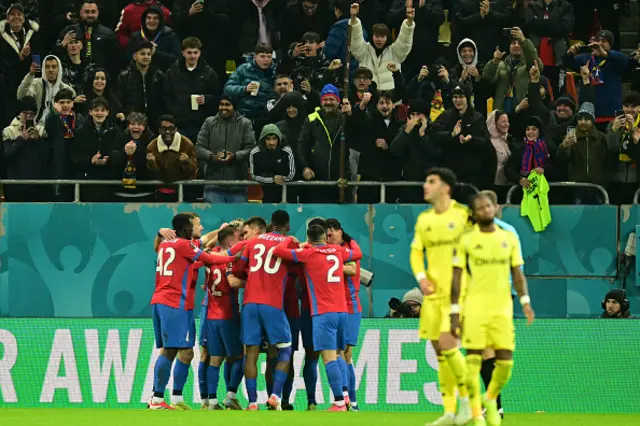 FCSB's Italian midfielder Juri Cisotti (hidden) is celebrated by team mates