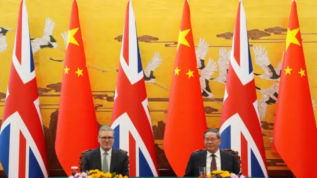 A photo of Keir Starmer and Li Qiang surrounded by Chinese and British flags at a signing ceremony
