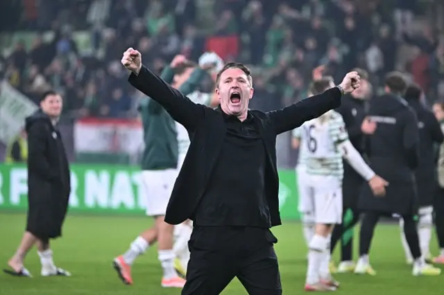 Robbie Keane celebrates a win after the game on the pitch