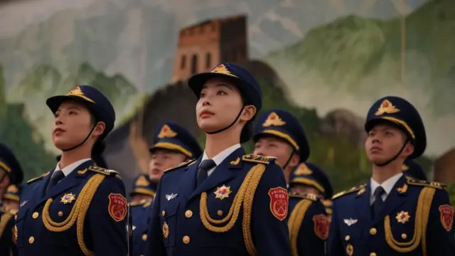 Chinese honour guard dressed in blue uniforms with gold trimmings